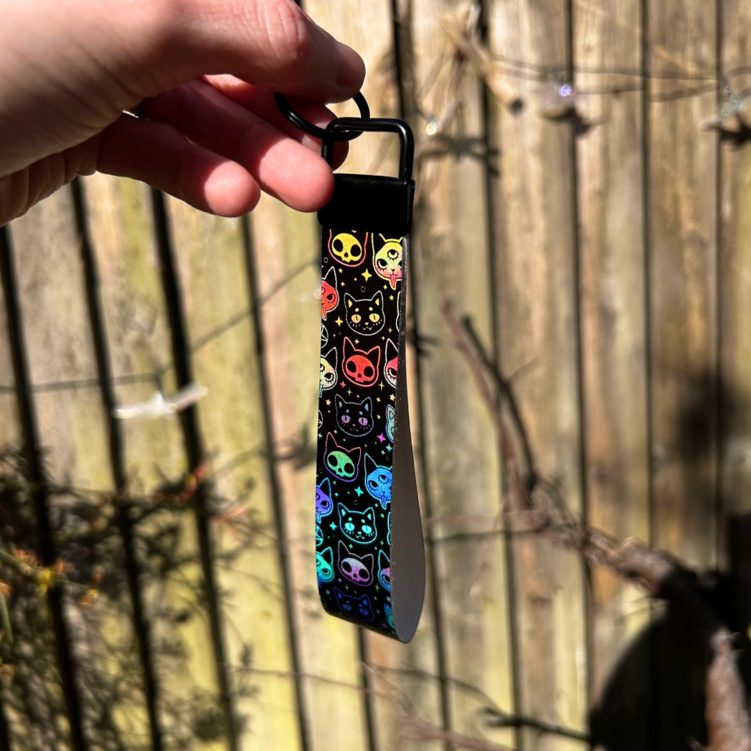 Black wristlet with holographic cat design
