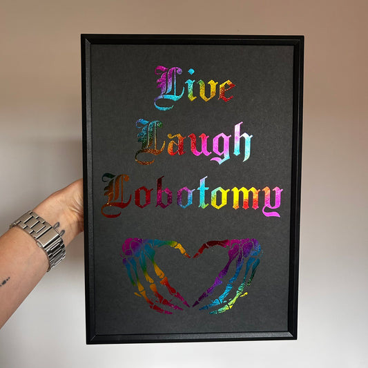 Framed artwork with colorful text and heart design on a dark background
Live laugh lobotomy