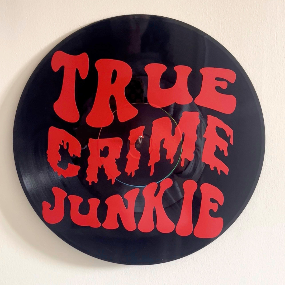 Vinyl record with red text 'TRUE CRIME JUNKIE' on a white background
