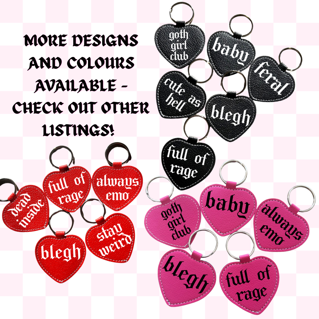 Heart-shaped keychains with various text designs on a checkered background